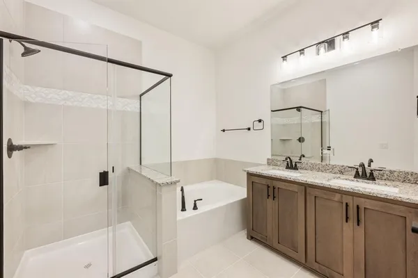 a bathroom with a tub sink shower and mirror