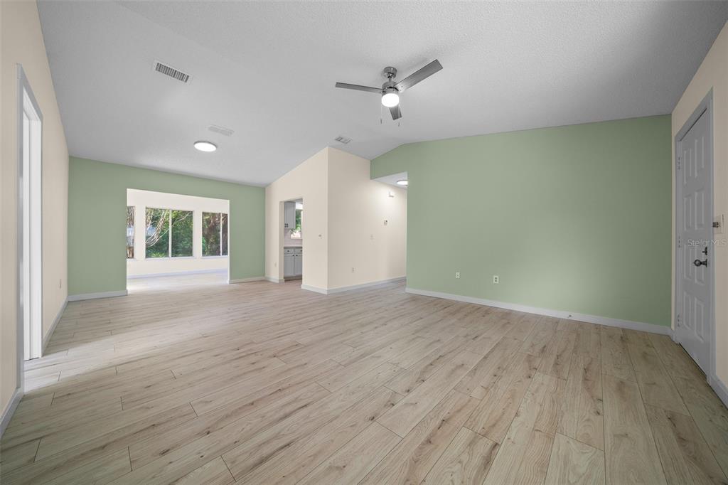 7556 Southwest 112th Lane Ocala, FL 34476 - Photo 14 of 37 wooden floor in an empty room with a window