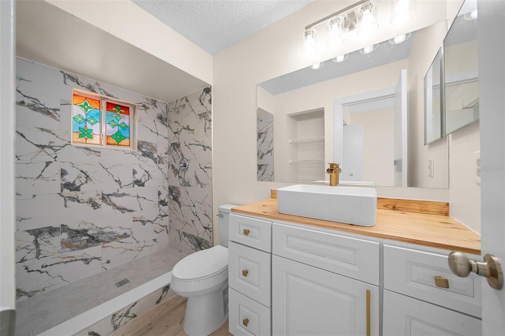 7556 Southwest 112th Lane Ocala, FL 34476 - Photo 20 of 37 a bathroom with a toilet sink and mirror