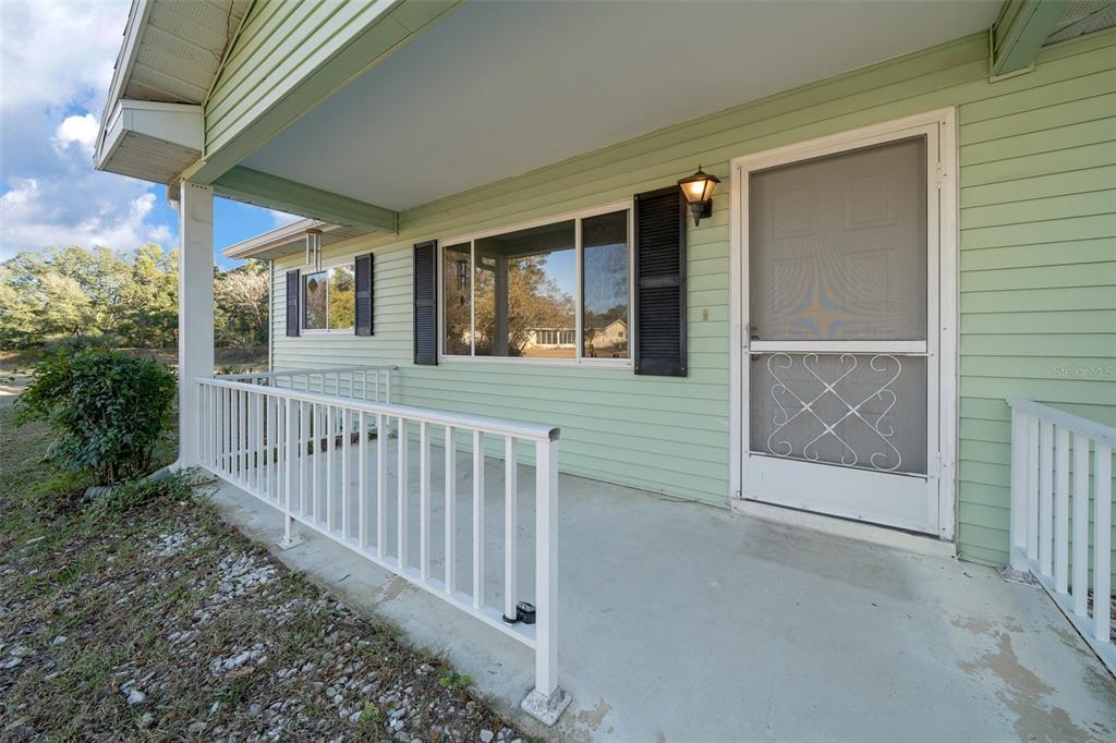 7556 Southwest 112th Lane Ocala, FL 34476 - Photo 2 of 37 a view of a porch with wooden floor and outdoor space