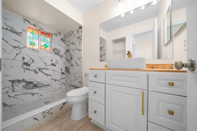 a bathroom with a sink a toilet and a shower curtain