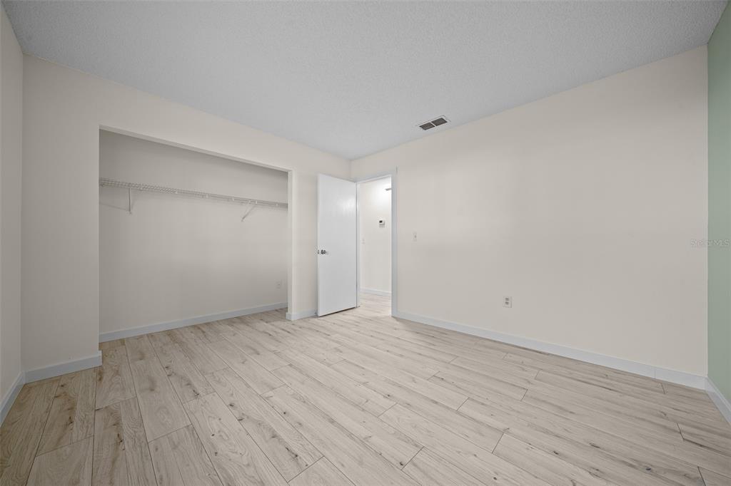 7556 Southwest 112th Lane Ocala, FL 34476 - Photo 23 of 37 a view of an empty room with wooden floor