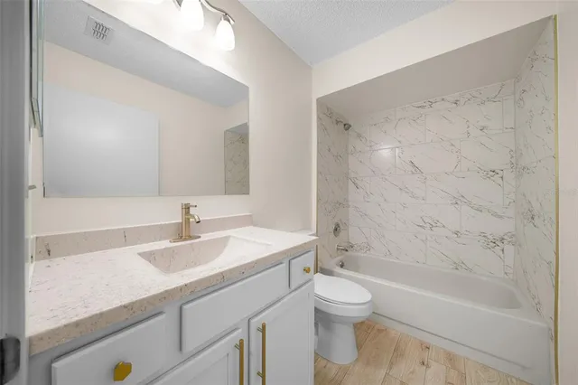 a bathroom with a sink a toilet and a bathtub