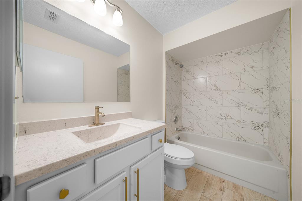 7556 Southwest 112th Lane Ocala, FL 34476 - Photo 24 of 37 a bathroom with a sink a toilet and a bathtub