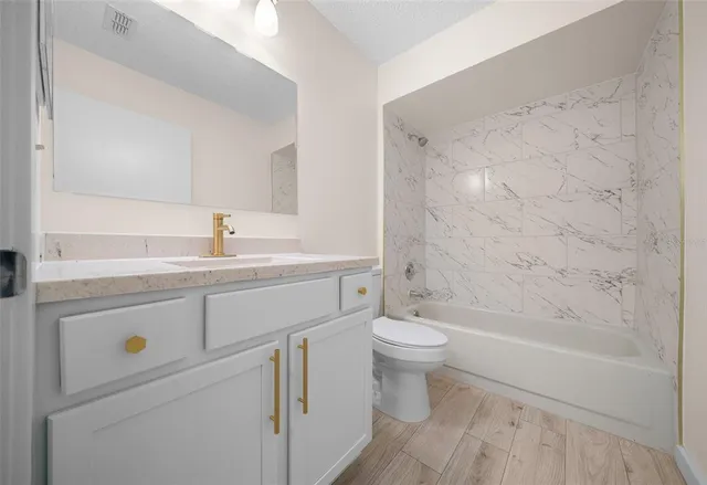 a bathroom with a sink a toilet and a bathtub