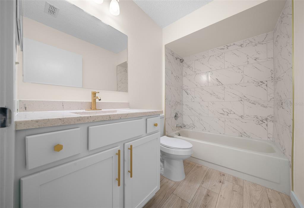 7556 Southwest 112th Lane Ocala, FL 34476 - Photo 25 of 37 a bathroom with a sink a toilet and a bathtub