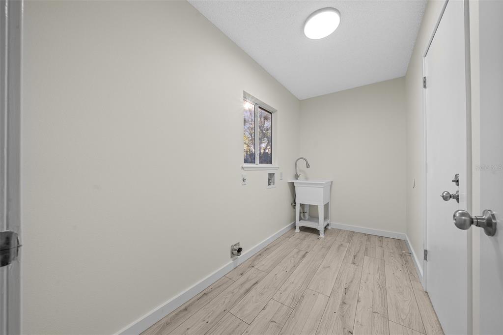 7556 Southwest 112th Lane Ocala, FL 34476 - Photo 28 of 37 a view of a room with wooden floor and a sink