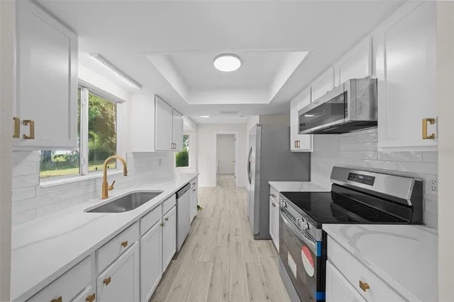 a kitchen with a sink and a stove top oven