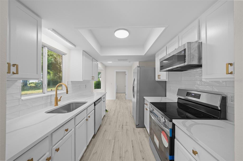 7556 Southwest 112th Lane Ocala, FL 34476 - Photo 3 of 37 a kitchen with a sink and a stove top oven