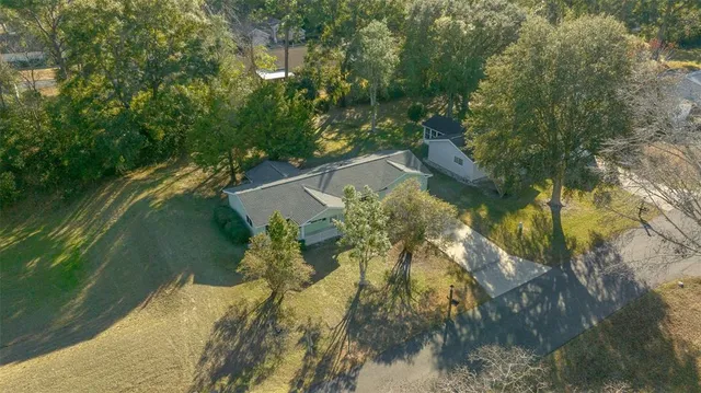 a view of yard with swimming pool and trees