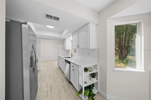 a kitchen with stainless steel appliances a white stove top oven and a refrigerator