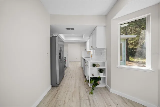 a view of kitchen with furniture and wooden floor