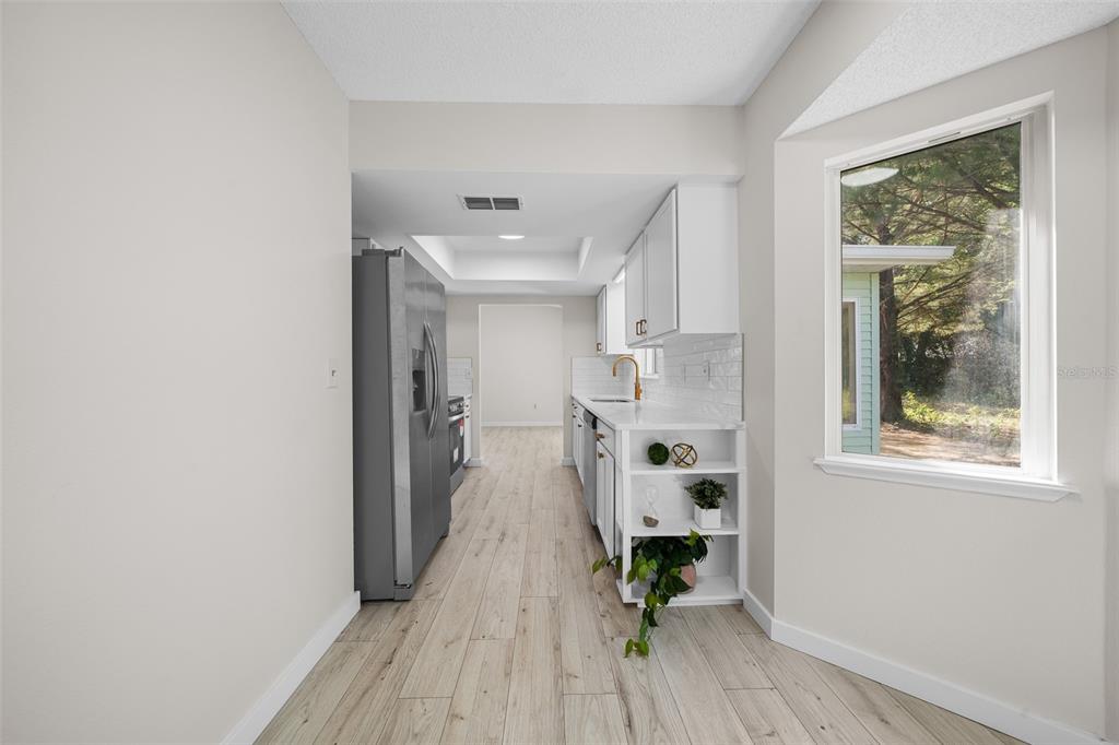 7556 Southwest 112th Lane Ocala, FL 34476 - Photo 10 of 37 a view of kitchen with furniture and wooden floor