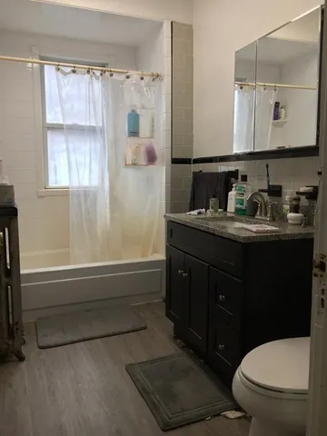 a living room with hard wood flooring