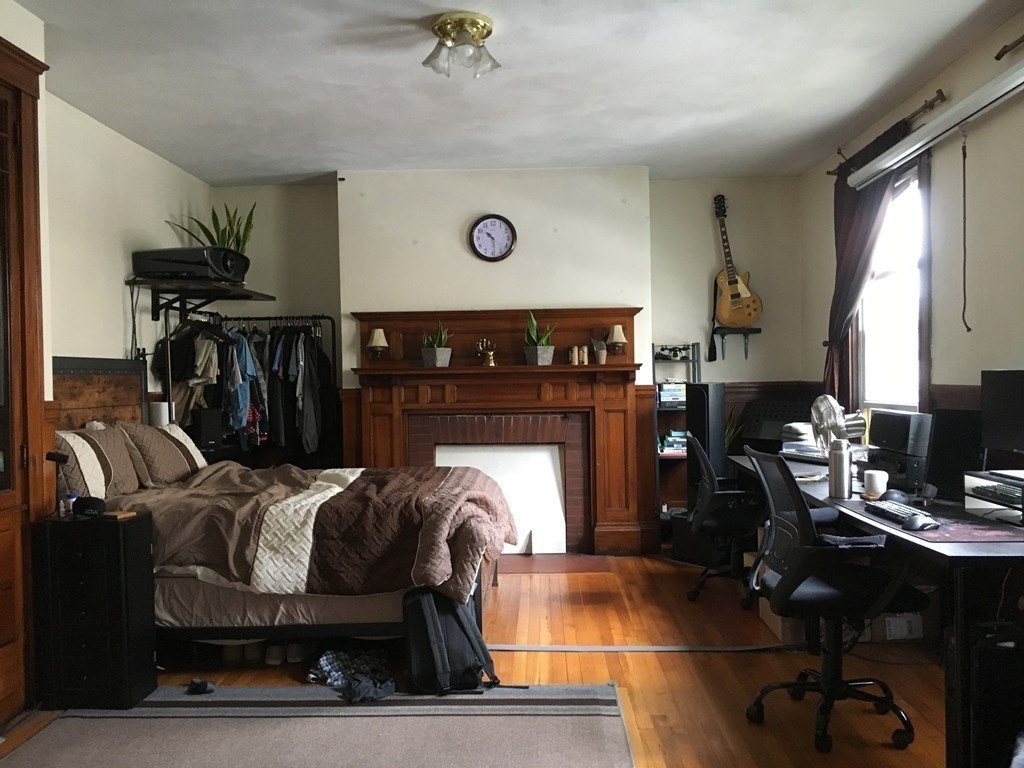 20 St Lukes Road, Unit 1 Boston, MA 02134 - Photo 6 of 10 a living room with furniture a flat screen tv and a fireplace