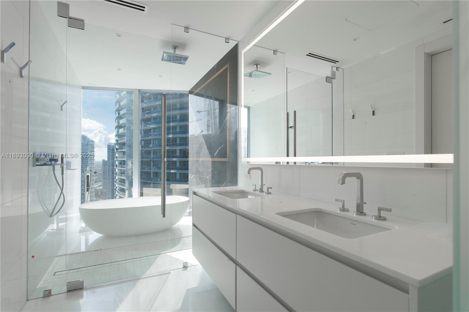 300 Biscayne Blvd Way, Unit 3307 Miami, FL 33131 - Photo 20 of 59 a bathroom with a sink double vanity mirror and bathtub