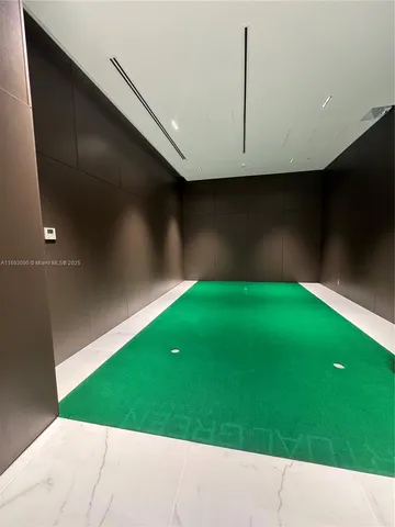 a living room with furniture and large windows