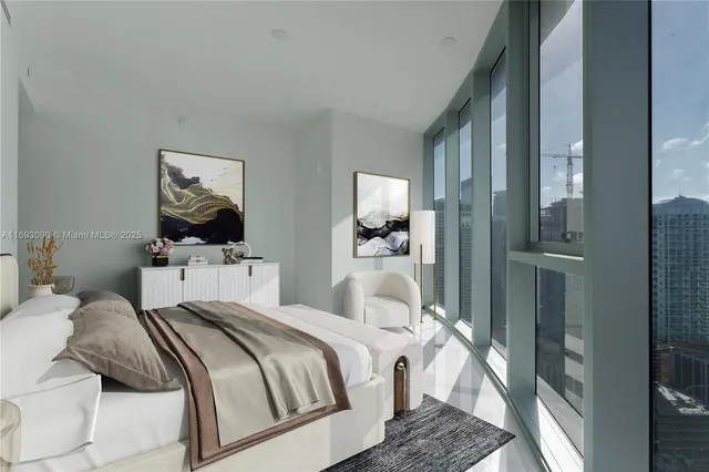 a bedroom with a large bed and a large window