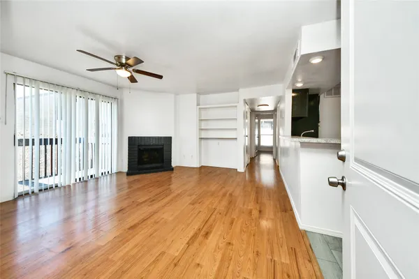 wooden floor in an empty room with a fireplace