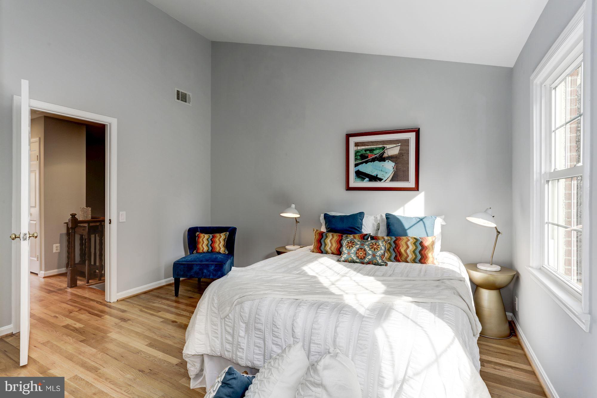 1221 Portner Road Alexandria, VA 22314 - Photo 10 of 30 a bedroom with a bed and wooden floor