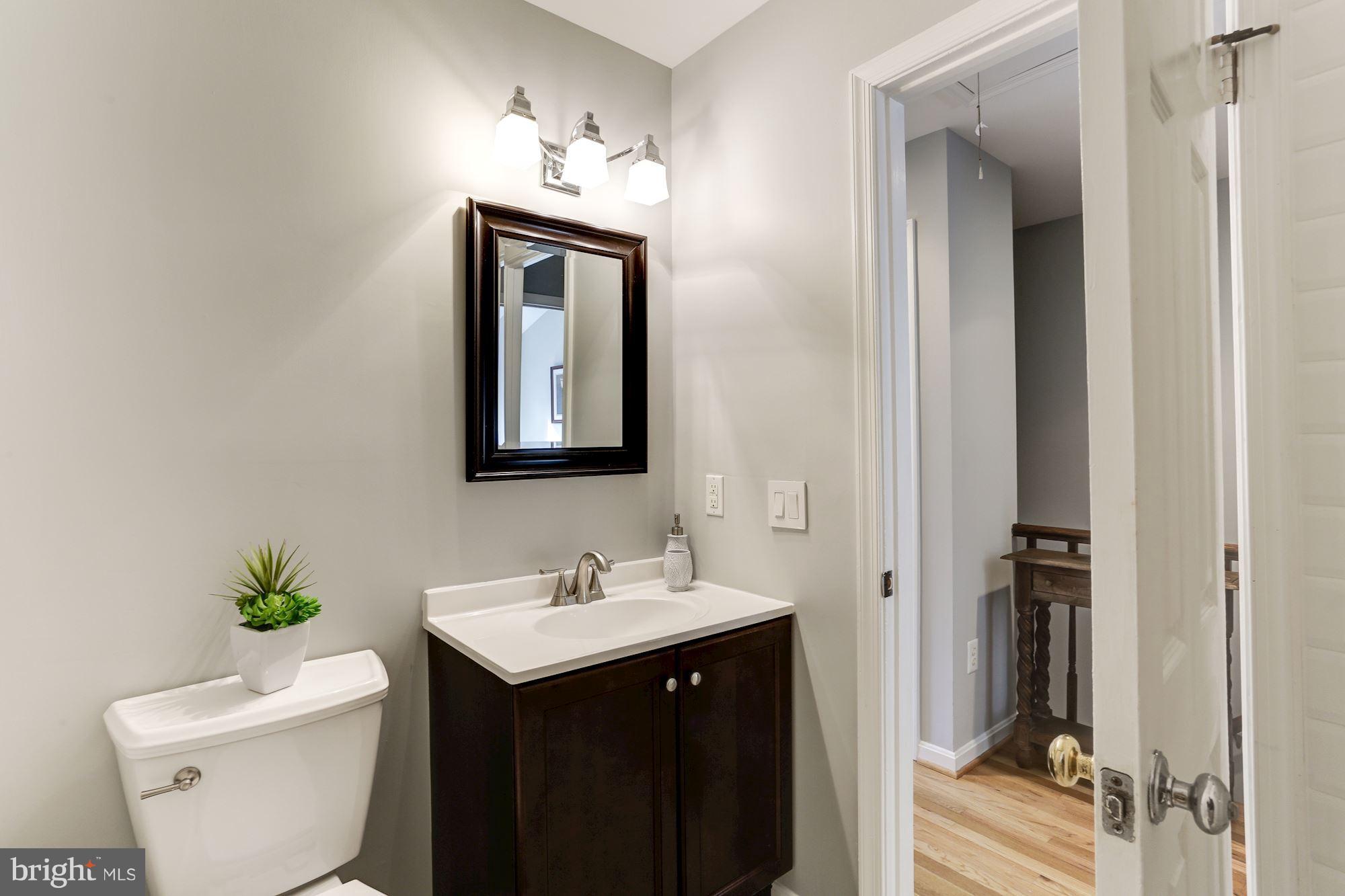 1221 Portner Road Alexandria, VA 22314 - Photo 11 of 30 a bathroom with a toilet sink and mirror