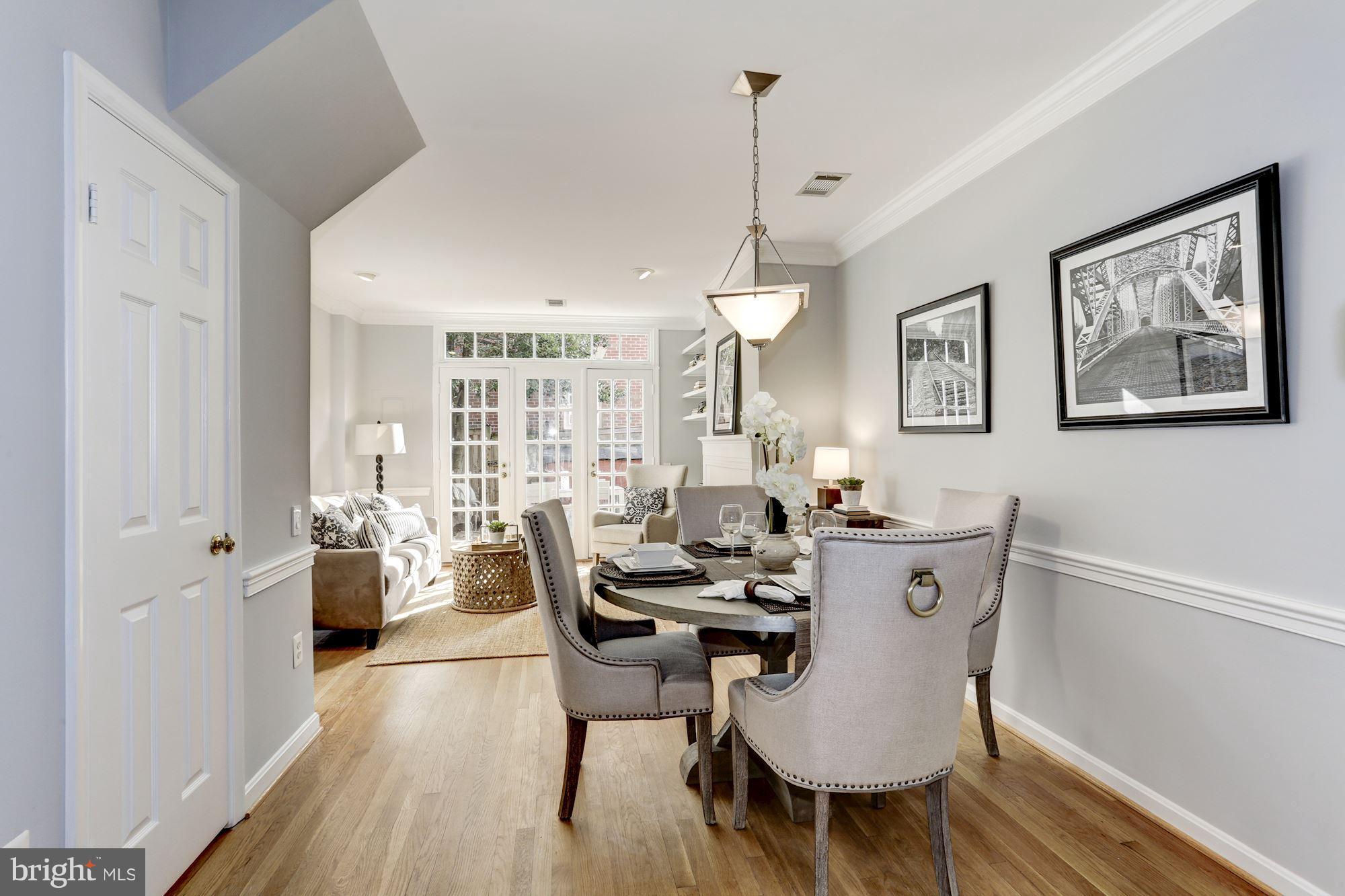1221 Portner Road Alexandria, VA 22314 - Photo 3 of 30 a view of a dining room and livingroom with furniture wooden floor a rug and a chandelier