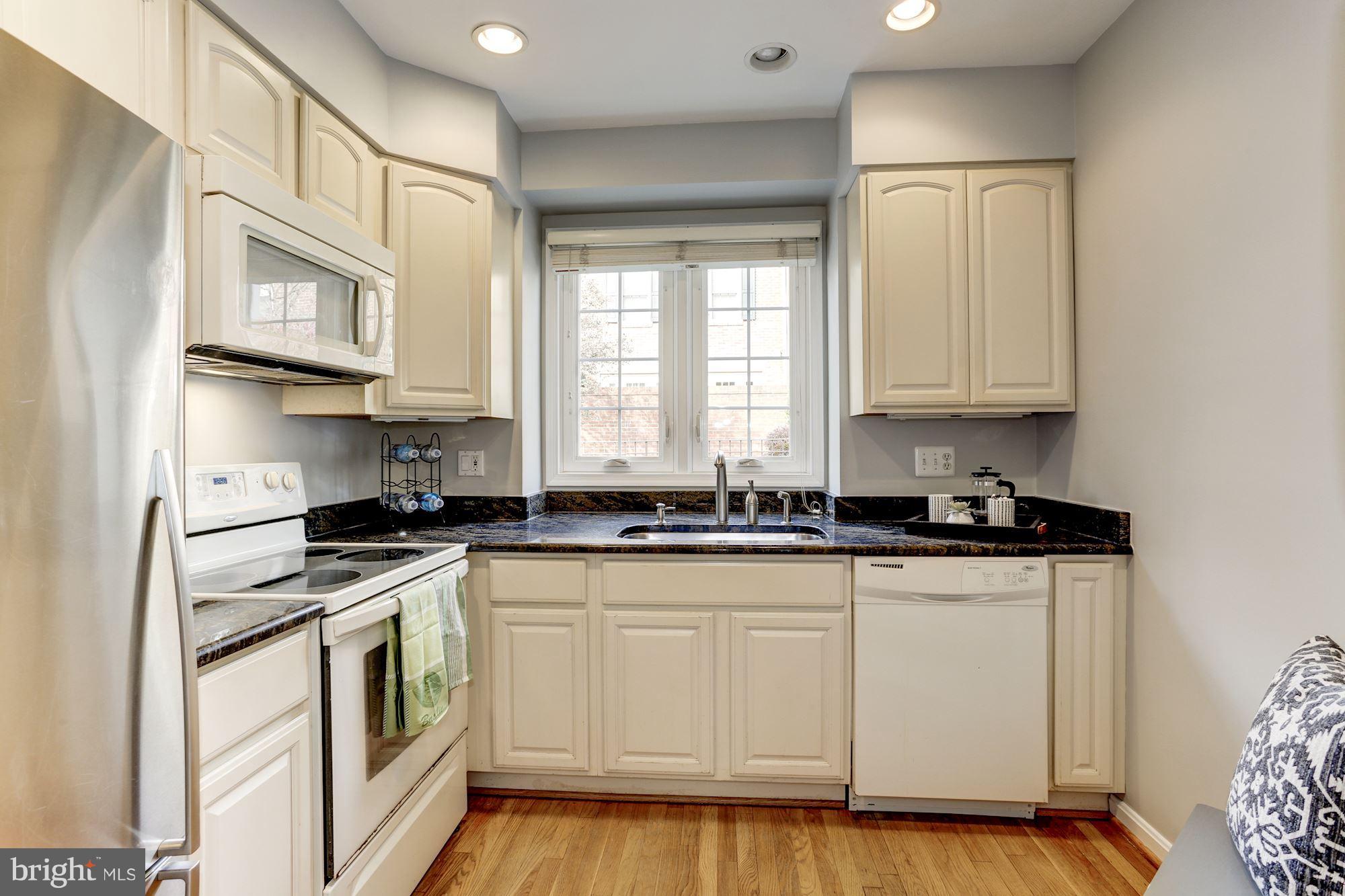 1221 Portner Road Alexandria, VA 22314 - Photo 5 of 30 a kitchen with stainless steel appliances granite countertop a stove a sink and white cabinets