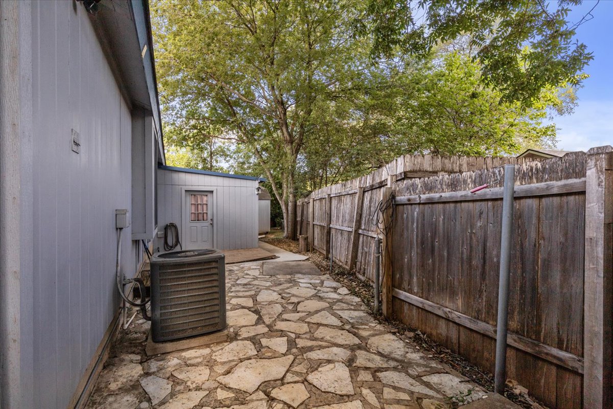 6200 Shadow Bend Austin, TX 78745 - Photo 26 of 33 A spacious backyard area features a unique flagstone patio, perfect for outdoor entertaining.