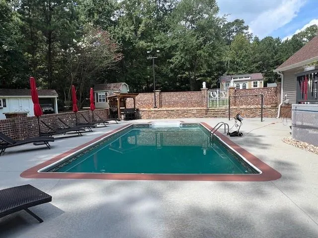 an outdoor space with pool and furniture