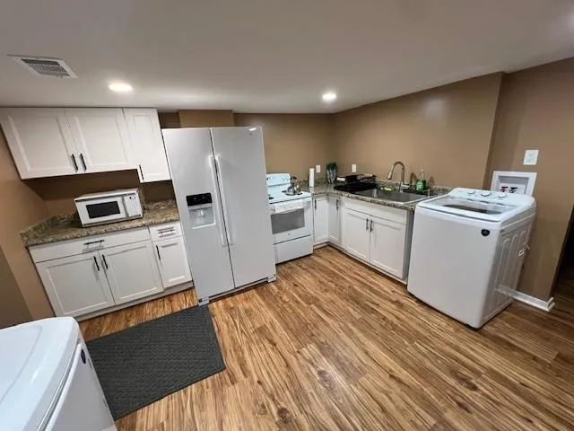 a kitchen with a sink refrigerator and microwave