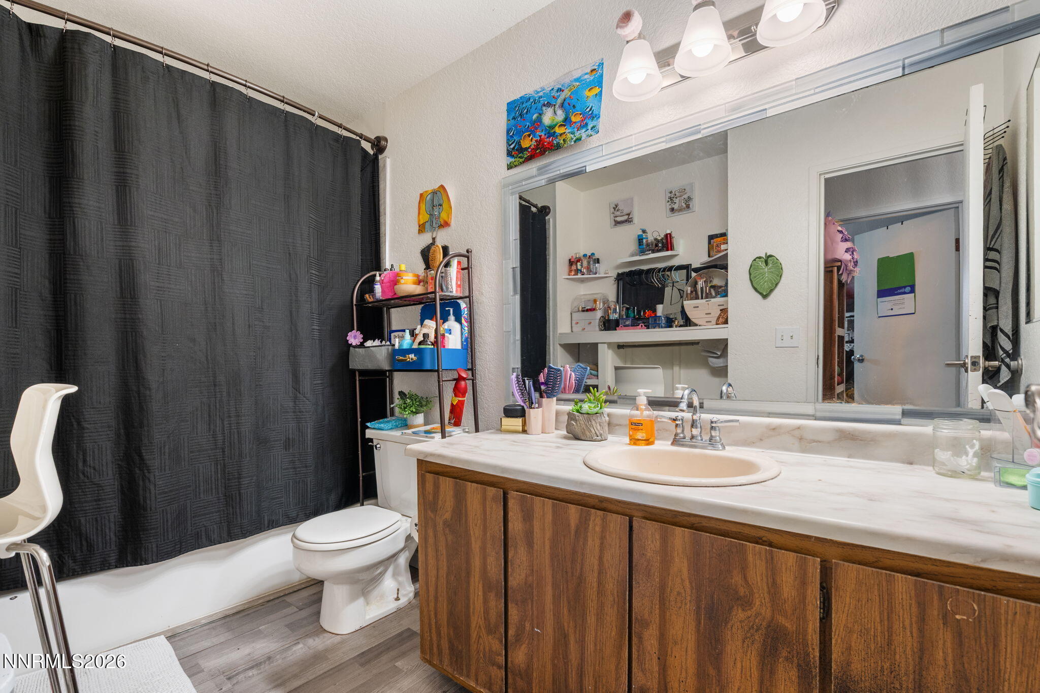 4604 Neil Road, Unit 164 Reno, NV 89502 - Photo 20 of 22 a bathroom with a sink vanity mirror and toilet