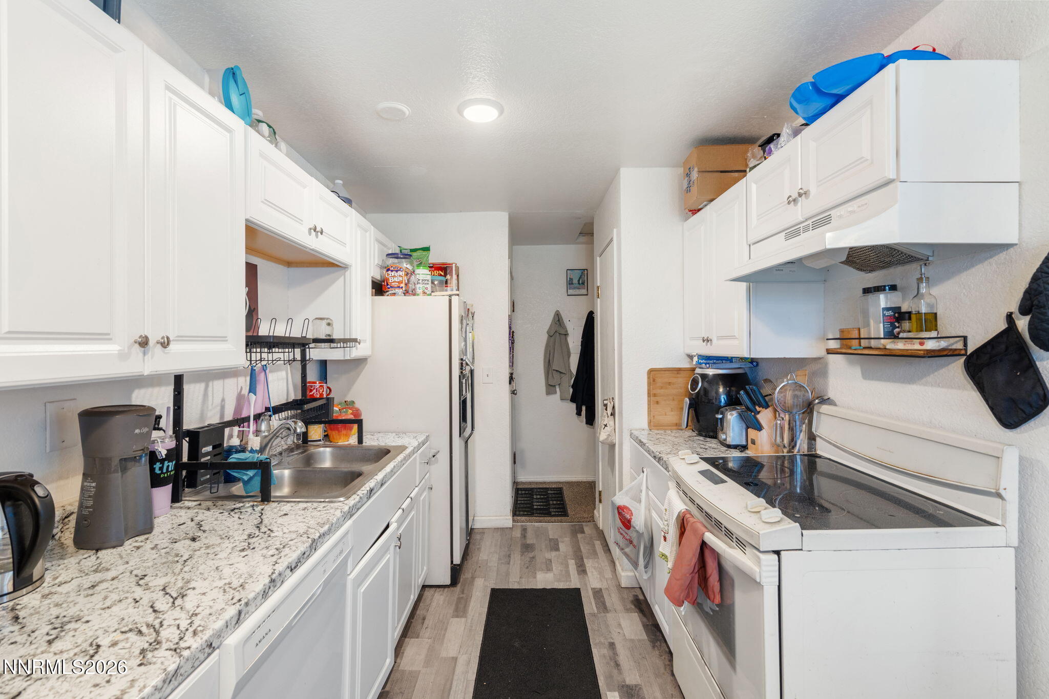 4604 Neil Road, Unit 164 Reno, NV 89502 - Photo 7 of 22 a kitchen with a sink stove and cabinets