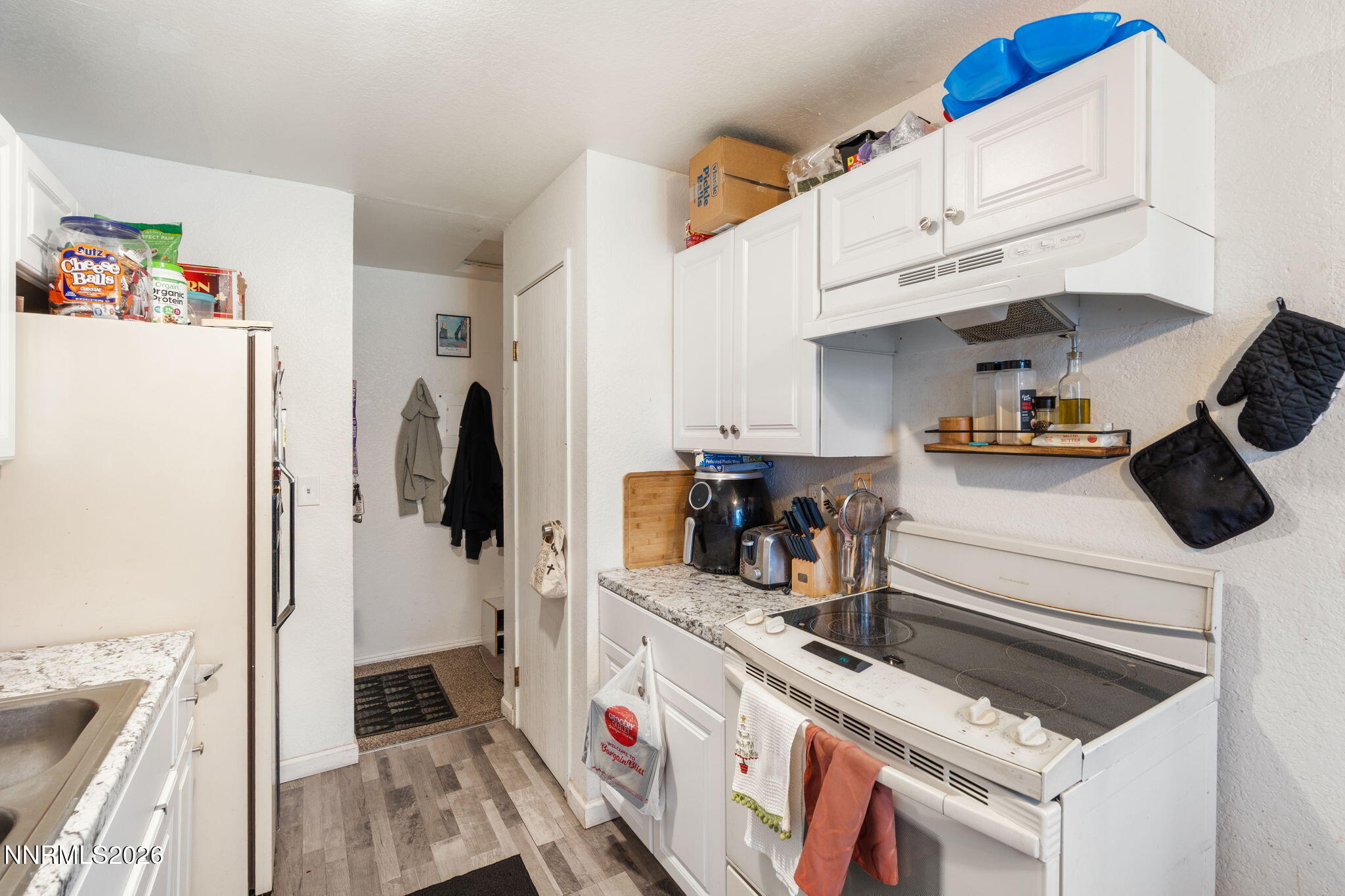 4604 Neil Road, Unit 164 Reno, NV 89502 - Photo 8 of 22 a kitchen with white cabinets and refrigerator