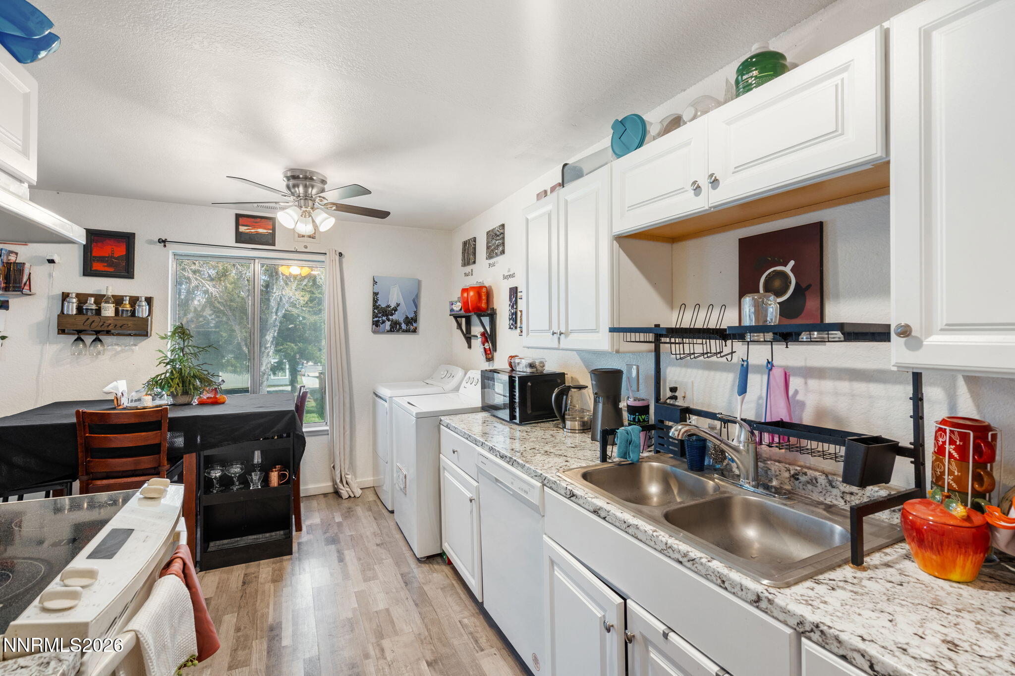 4604 Neil Road, Unit 164 Reno, NV 89502 - Photo 10 of 22 a kitchen filled counter top space a sink a stove and cabinets