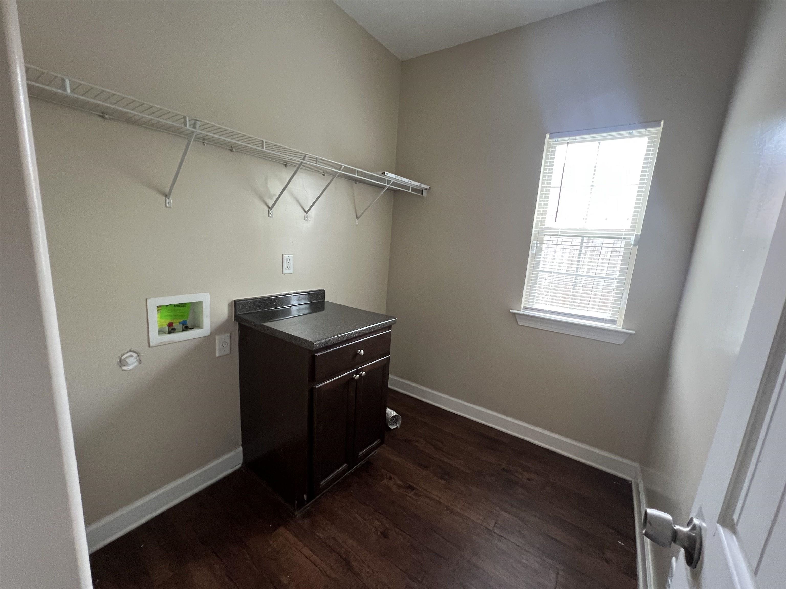 7317 Patsy Circle North Memphis, TN 38125 - Photo 14 of 26 Laundry room featuring dark wood-style flooring, laundry area, baseboards, and hookup for a washing machine