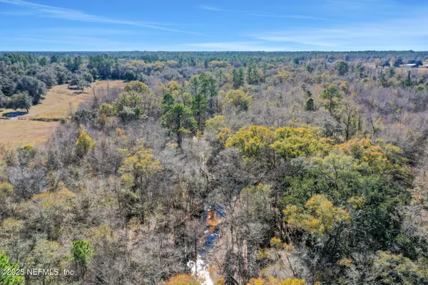 a view of a field with a city view
