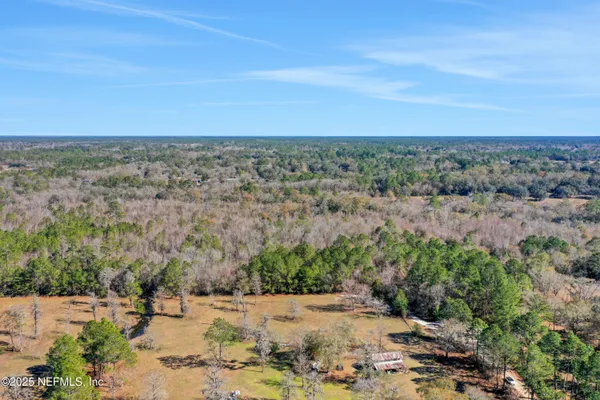 an aerial view of a houses with a yard