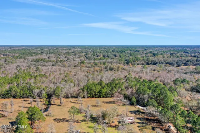 an aerial view of a houses with a yard