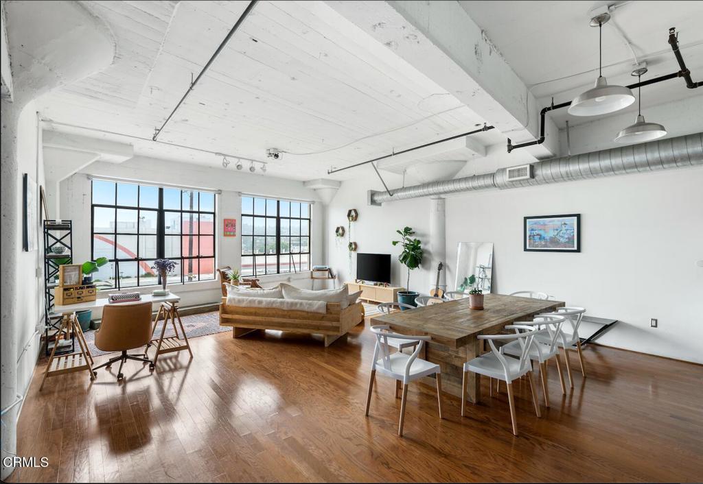 a view of a dining room with furniture window and wooden floor