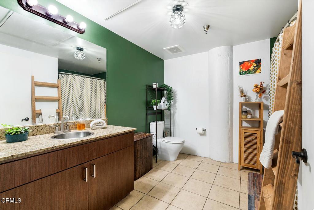 200 North San Fernando Road, Unit 416 Los Angeles, CA 90031 - Photo 9 of 21 a bathroom with a sink mirror and toilet