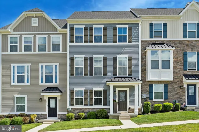 a front view of a residential apartment building with a yard