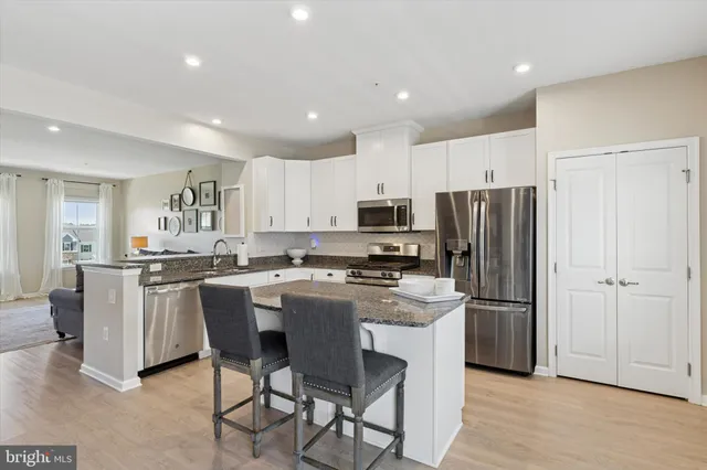 a kitchen with stainless steel appliances a refrigerator stove microwave and cabinets