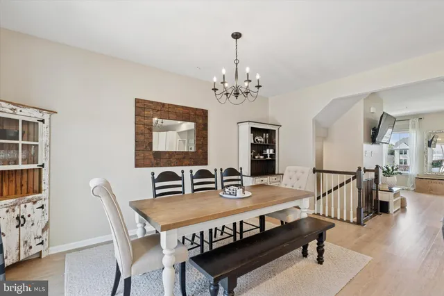 a view of a dining room with furniture wooden floor and chandelier