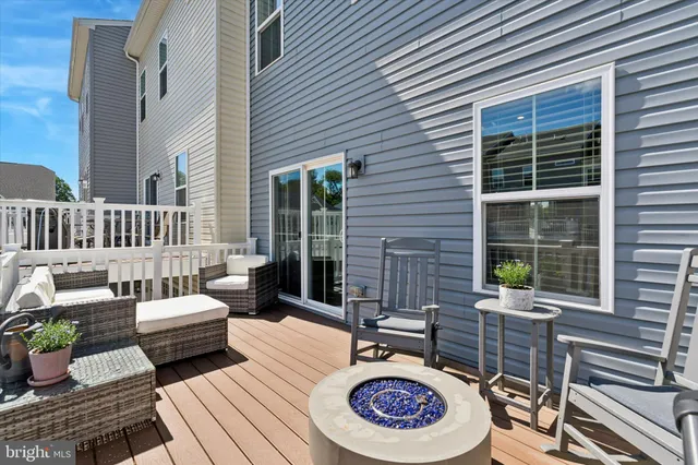 a view of a patio with couches table and chairs and potted plants