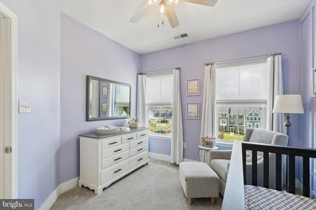 a bedroom with furniture and a large window