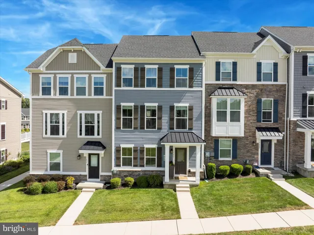 a front view of a residential apartment building with a yard