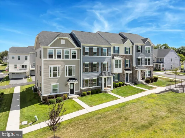 a front view of residential houses with yard and swimming pool
