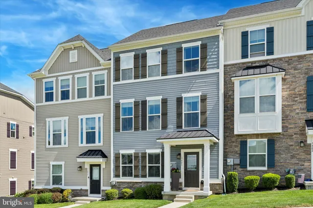 a front view of a residential apartment building with a yard