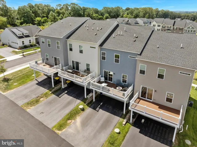 an aerial view of a residential houses with outdoor space
