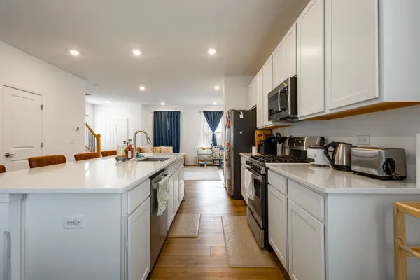 a kitchen with stainless steel appliances a refrigerator sink and microwave